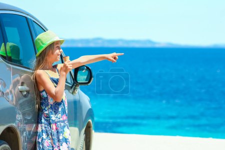Photo for Happy child with ice cream by the sea on weekend travel shore - Royalty Free Image