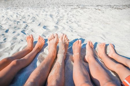 Photo for Feet of a happy family near the seashore in nature weekend travel - Royalty Free Image