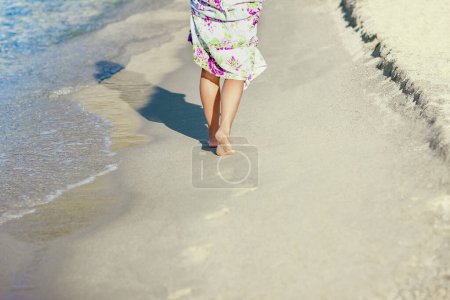 Photo for Footprints and feet along the seashore in nature weekend travel - Royalty Free Image