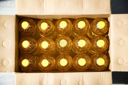 Photo for Many bottles of sunflower oil in box background - Royalty Free Image