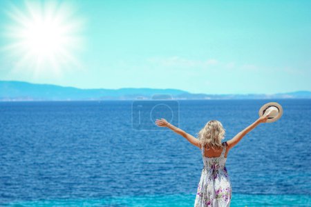Photo for Happy girl near the seashore in nature weekend travel - Royalty Free Image