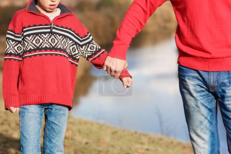 Photo for Happy father holding child's hand concept family support relations - Royalty Free Image