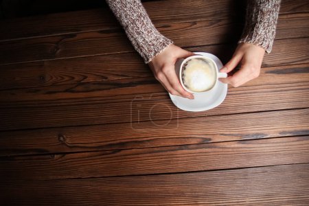 Photo for Female hands and coffee on wooden background - Royalty Free Image