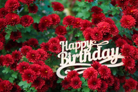 Photo for Happy birthday sign with red flowers - Royalty Free Image