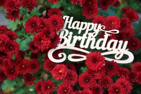 Photo for Happy birthday sign wiyh red flowers - Royalty Free Image