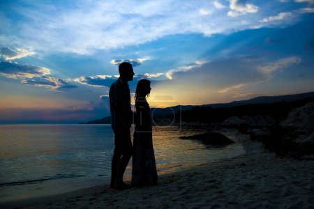 Photo for Happy couple silhouette by the Greek sea on the shore background - Royalty Free Image