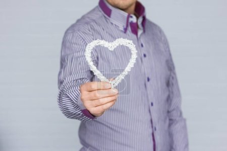 Photo for Heart in human hands on white brick background - Royalty Free Image