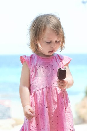 Photo for Happy child girl with ice cream by the sea in nature in the park journey - Royalty Free Image
