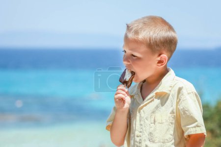 Photo for Happy child boy with ice cream by the sea in nature in the park journey - Royalty Free Image