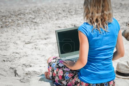 Photo for Happy man girl with laptop near the seaside weekend travel - Royalty Free Image