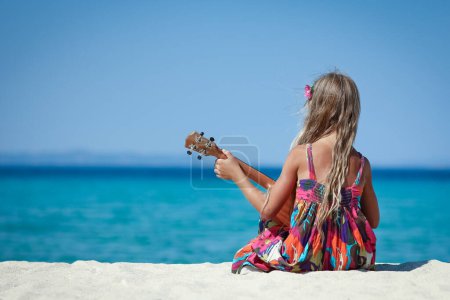 Photo for Happy child with ukulele at iorya in nature weekend travel - Royalty Free Image