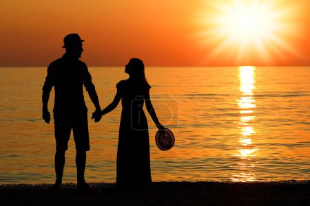 Photo for Happy couple by the sea in nature silhouette weekend travel - Royalty Free Image