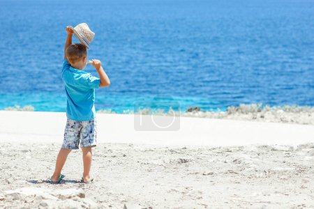 Téléchargez les photos : Enfant heureux près de la mer dans la nature lors d'un week-end - en image libre de droit