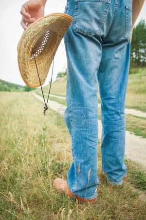 Photo for Cowboy legs in shoes in the park on nature background. The man at the ranch. - Royalty Free Image