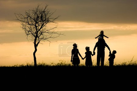Photo for Happy family silhouette on nature in park background - Royalty Free Image