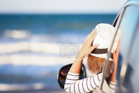 Photo for Happy girl in the car by the sea in nature on vacation travel - Royalty Free Image