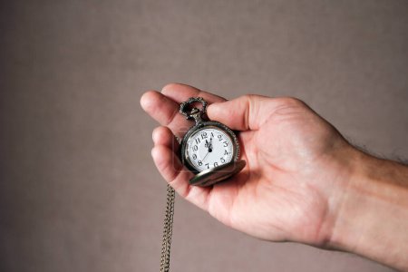 Photo for Pocket watch in the hands of a man - Royalty Free Image