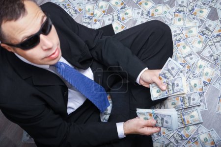 Photo for Happy guy with money in his hands for the development of shopping business and a great trip - Royalty Free Image