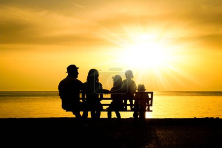Foto de Familia feliz en la naturaleza junto al mar en una silueta de viaje - Imagen libre de derechos