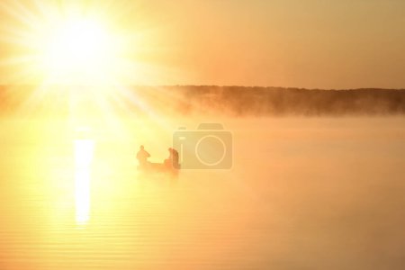 Photo for Fisherman on the river in the fog in the park on the nature - Royalty Free Image
