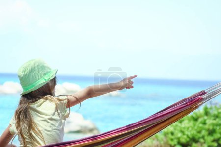 Photo for Happy child by the sea on hammock in greece background - Royalty Free Image