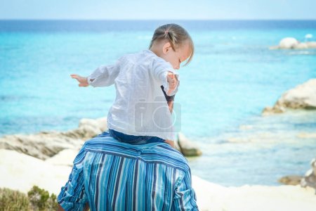 Photo for Happy parent with child by the sea greece outdoors - Royalty Free Image
