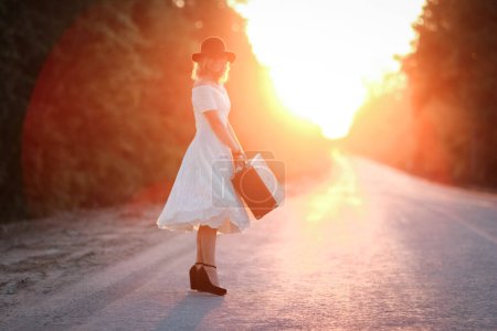 Photo for Vintage girl with hat with a suitcase hitchhiking - Royalty Free Image