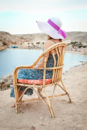 Photo for Stylish beautiful girl in hat on chair background - Royalty Free Image