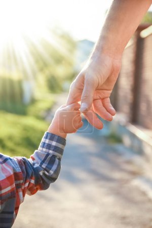 Photo for The parent holding the child's hand with a happy background - Royalty Free Image
