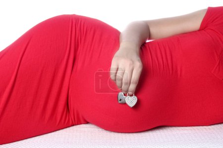 Photo for Happy pregnant girl lies on white background - Royalty Free Image