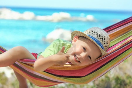 Photo for Happy child by the sea on hammock in greece background - Royalty Free Image