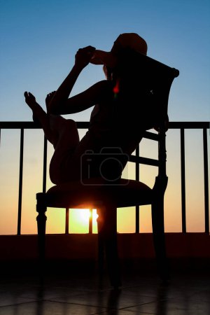 Photo for Silhouette of a girl on a chair on a nature background - Royalty Free Image