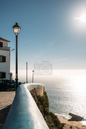 Photo for Scenic view onto Ericeira street and ocean on a bright sunny day, Portugal - Royalty Free Image