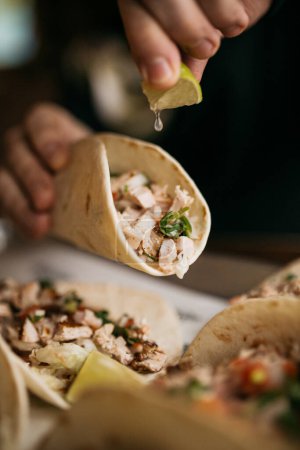 Photo for Squeeze lime juice on a taco served at the restaurant - Royalty Free Image