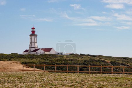 Photo for Landscape of Cape Espichel Lighthouse on cliff in Sesimbra, Portugal - Royalty Free Image