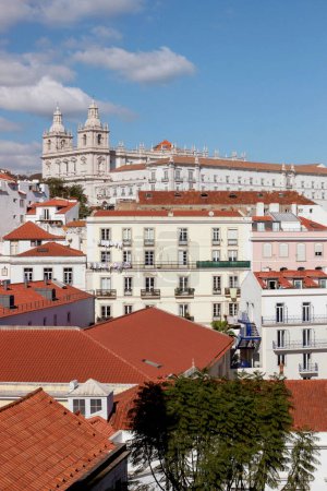 cityscape of old buildings with blue ocean at Lisbon viewpoint