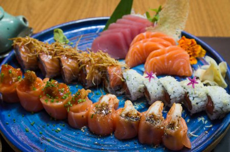 Photo for Combined of differents japanese sushi on a elegant blue plate. - Royalty Free Image