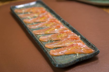 Photo for Delicious premium salmon sashimi arranged on an elegant handmade platter. - Royalty Free Image