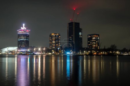 Téléchargez les photos : City scenic from Amsterdam in the harbor area in the Netherlands at night - en image libre de droit