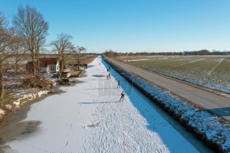Photo for Ice skating on the canals in the countryside from the Netherlands in winter - Royalty Free Image