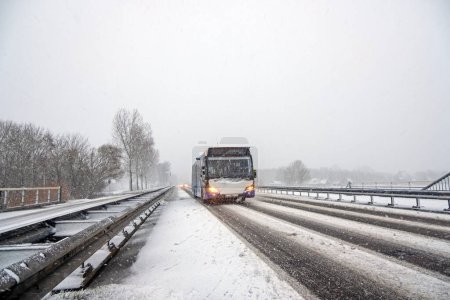 Photo for Bus driving in a snow storm in Noord Holland the Netherlands - Royalty Free Image