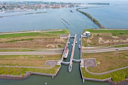 Photo for Aerial from naviduct Krabbersgat near Enkhuizen in the Netherlands, between the Markermeer and the IJsselmeer. A naviduct is a combination of an aqueduct and a sluice or sluice - Royalty Free Image
