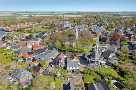 Photo for Aerial from the Andreas church and windmill in traditional town Spijk, Groningen, Netherlands - Royalty Free Image