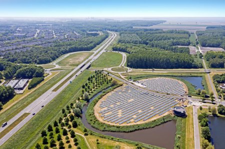 Photo for Aerial  from a solar Panel Farm with unique design in a form of an island.  Energy is used to power city heating in a modern sustainable district Noorderplassen in Almere, The Netherlands. - Royalty Free Image