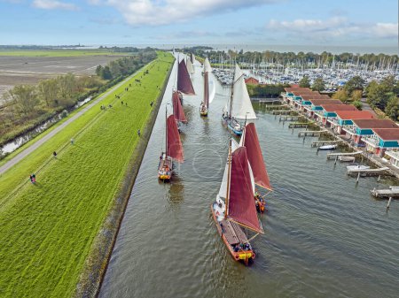 Photo for Aerial from a sailing competition the Workumer Strontrace with traditional sailing boats at Workum in the Netherlands - Royalty Free Image