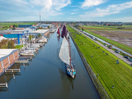 Photo for Aerial from a sailing competition the Workumer Strontrace with traditional sailing boats at Workum in the Netherlands - Royalty Free Image