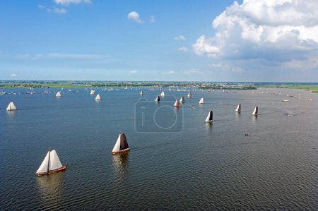 Photo for Aerial from traditional skutsjesilen with ancient boats on the Heeger meer in Friesland in the Netherlands - Royalty Free Image