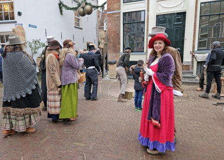 Photo for Deventer, Netherlands, December 16, 2023:People in the streets of Deventer in victorian style cloting during the Dickens Festival - Royalty Free Image