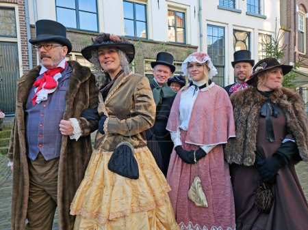 Photo for Deventer, Netherlands, December 16, 2023:People in the streets of Deventer in victorian style cloting during the Dickens Festival - Royalty Free Image