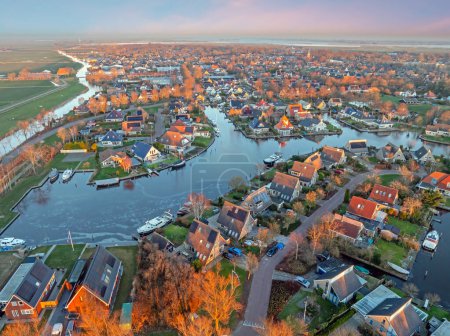 Photo for Aerial view on the traditional village Koudum in Friesland the Netherlands at sunset in winter - Royalty Free Image